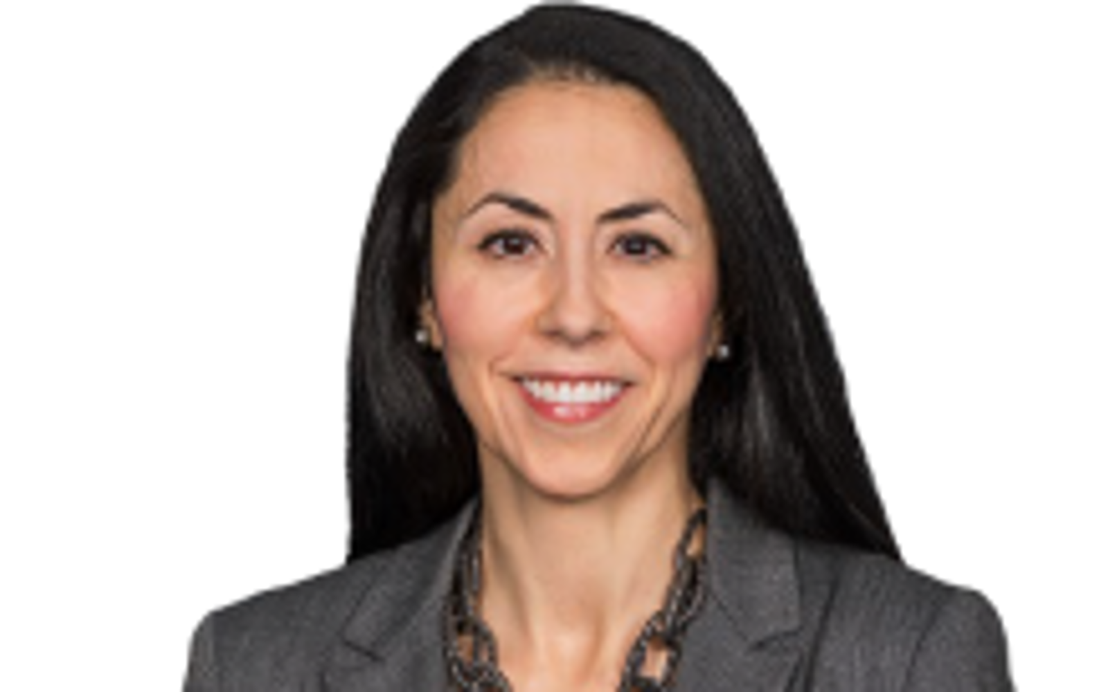 Woman with dark hair wearing a grey blazer. 