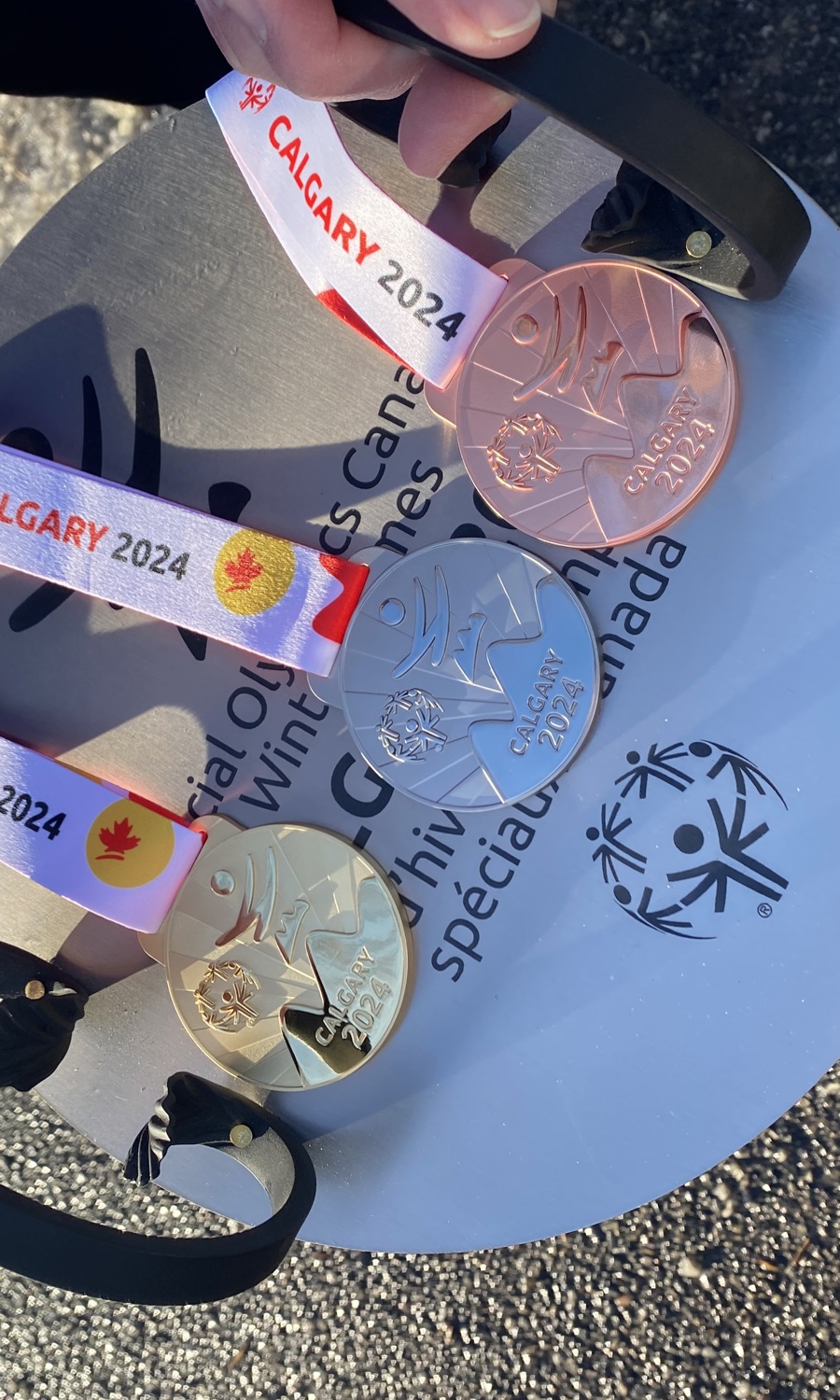 A close up image of gold, silver, and bronze medals.