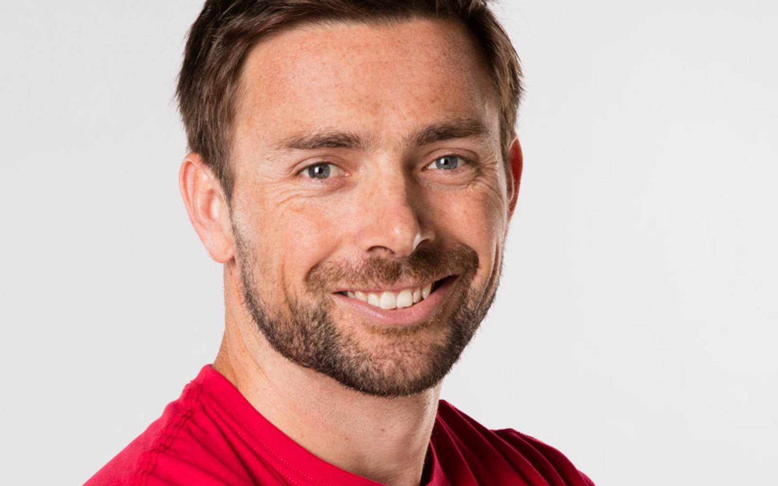 Headshot of a man in a red Canada tshirt. 