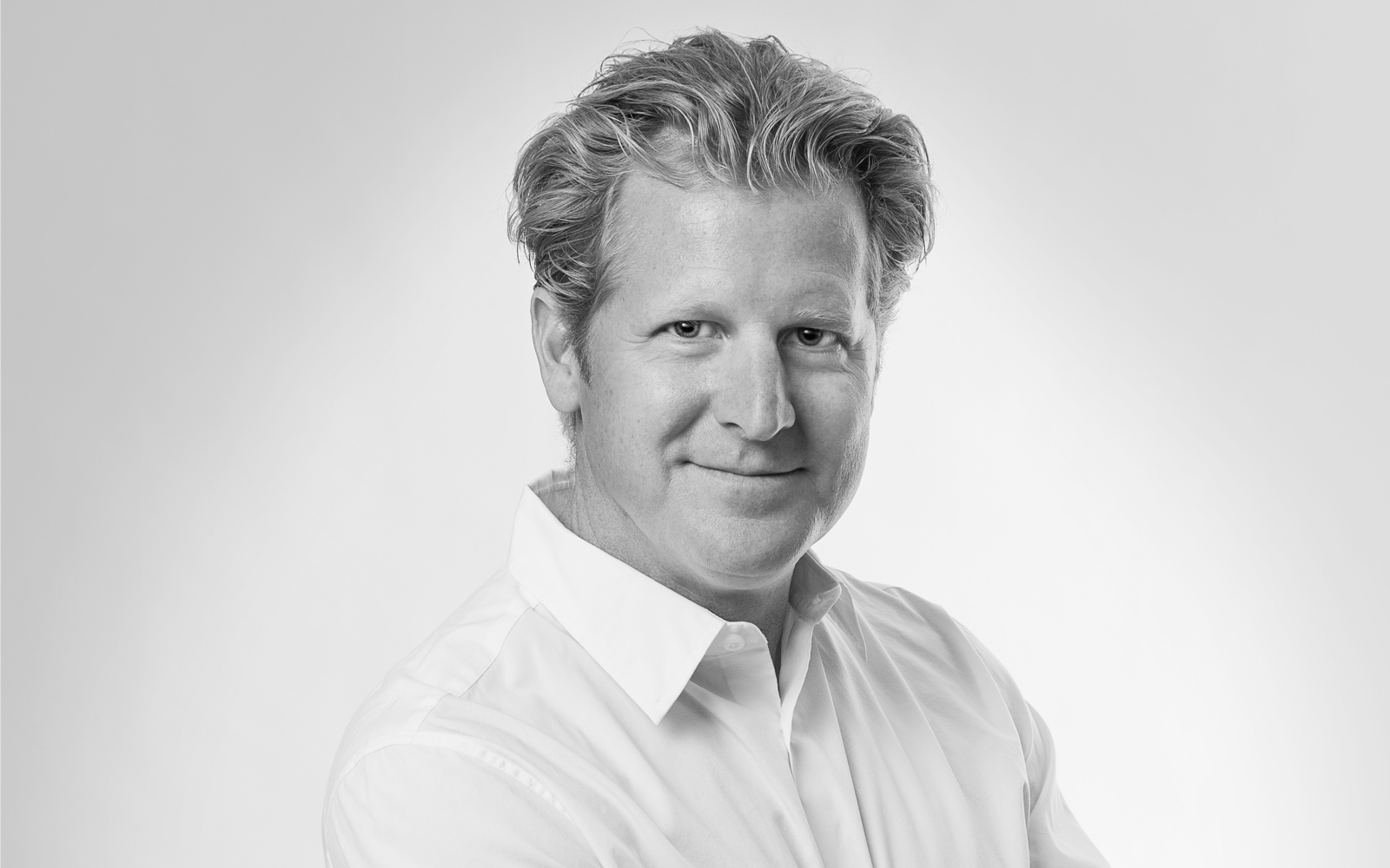 Headshot of a man in a dress shirt