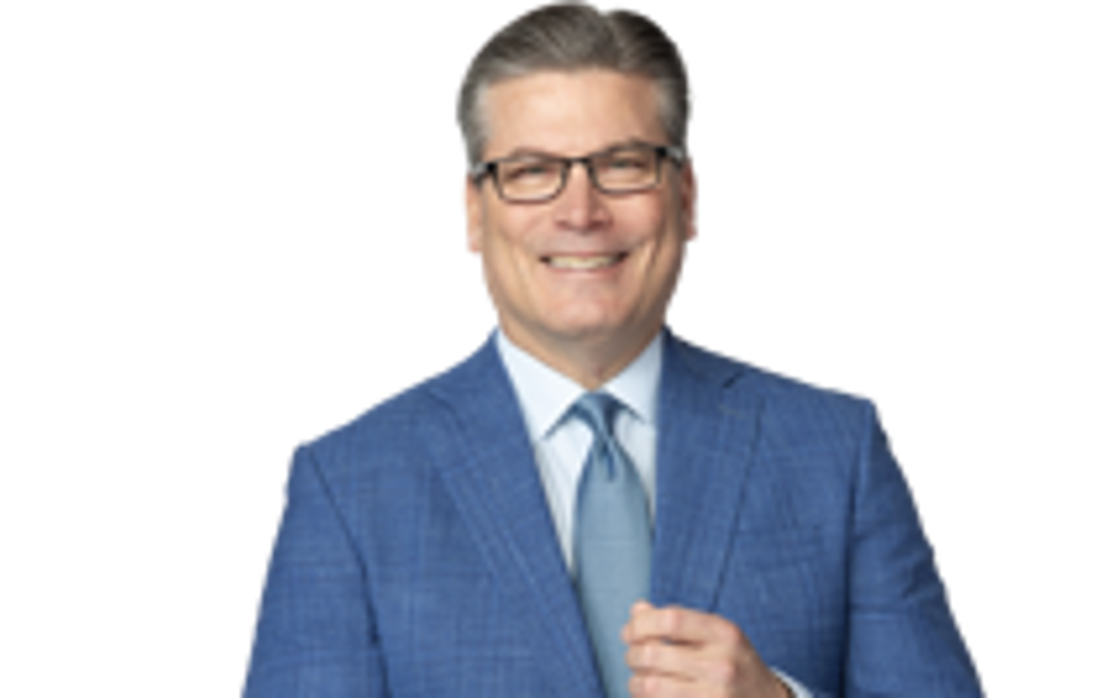 Man in blue suit smiling at camera. 