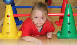 A collage image of two separate photos. The photo on the left shows a little girl crawling underneath a small obstacle course made of colourful pylons and sticks. The photo on the right shows a little boy hitting a ball with a baseball bat. It is an action shot photo.