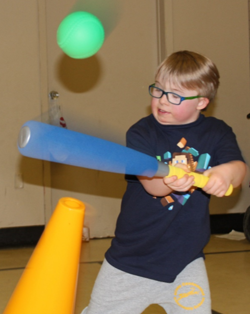 A collage image of two separate photos. The photo on the left shows a little girl crawling underneath a small obstacle course made of colourful pylons and sticks. The photo on the right shows a little boy hitting a ball with a baseball bat. It is an action shot photo.