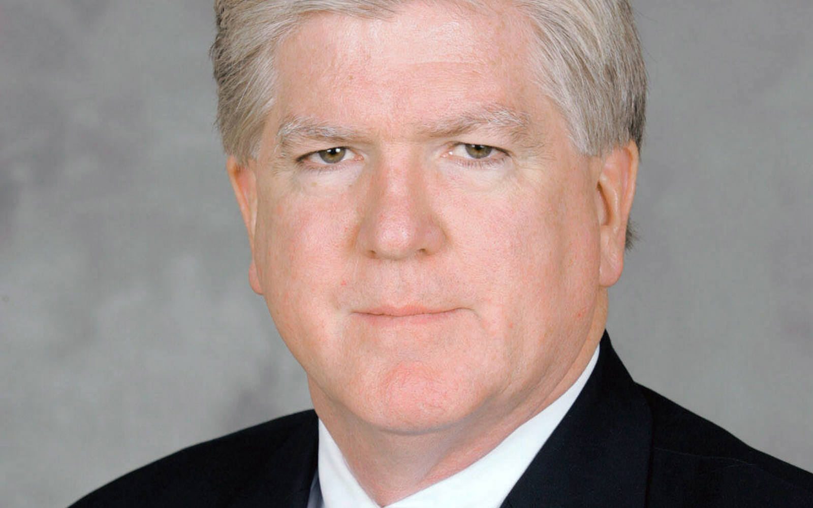 Headshot of a man wearing a suit