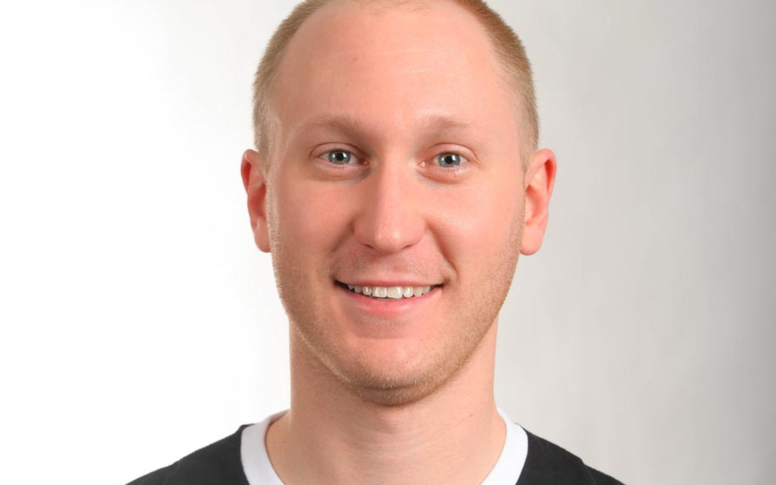 Headshot of a man wearing a jersey with Canadian Olympic Team Winter Games 2014. 