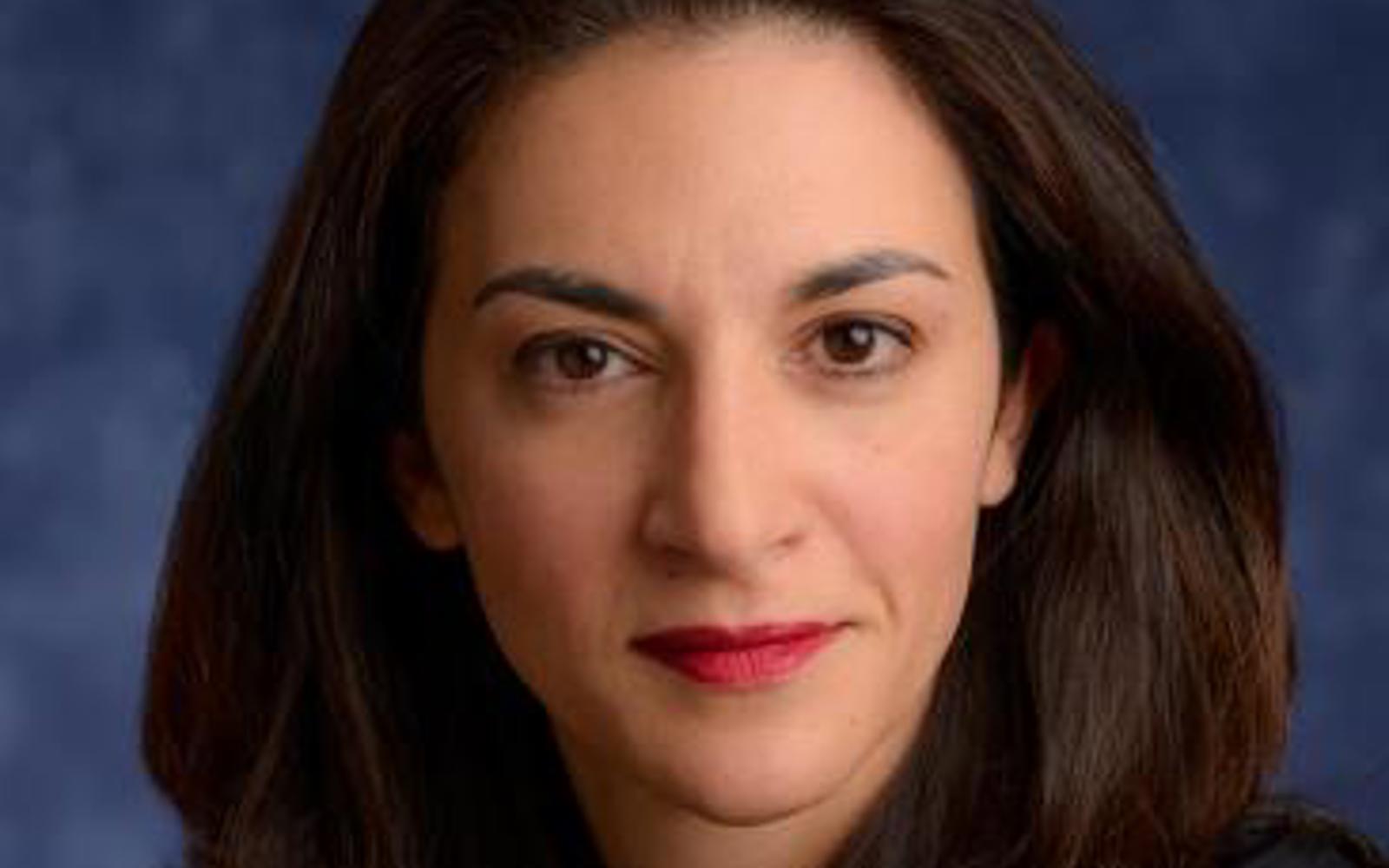 Image of a woman's face with long dark hair. 