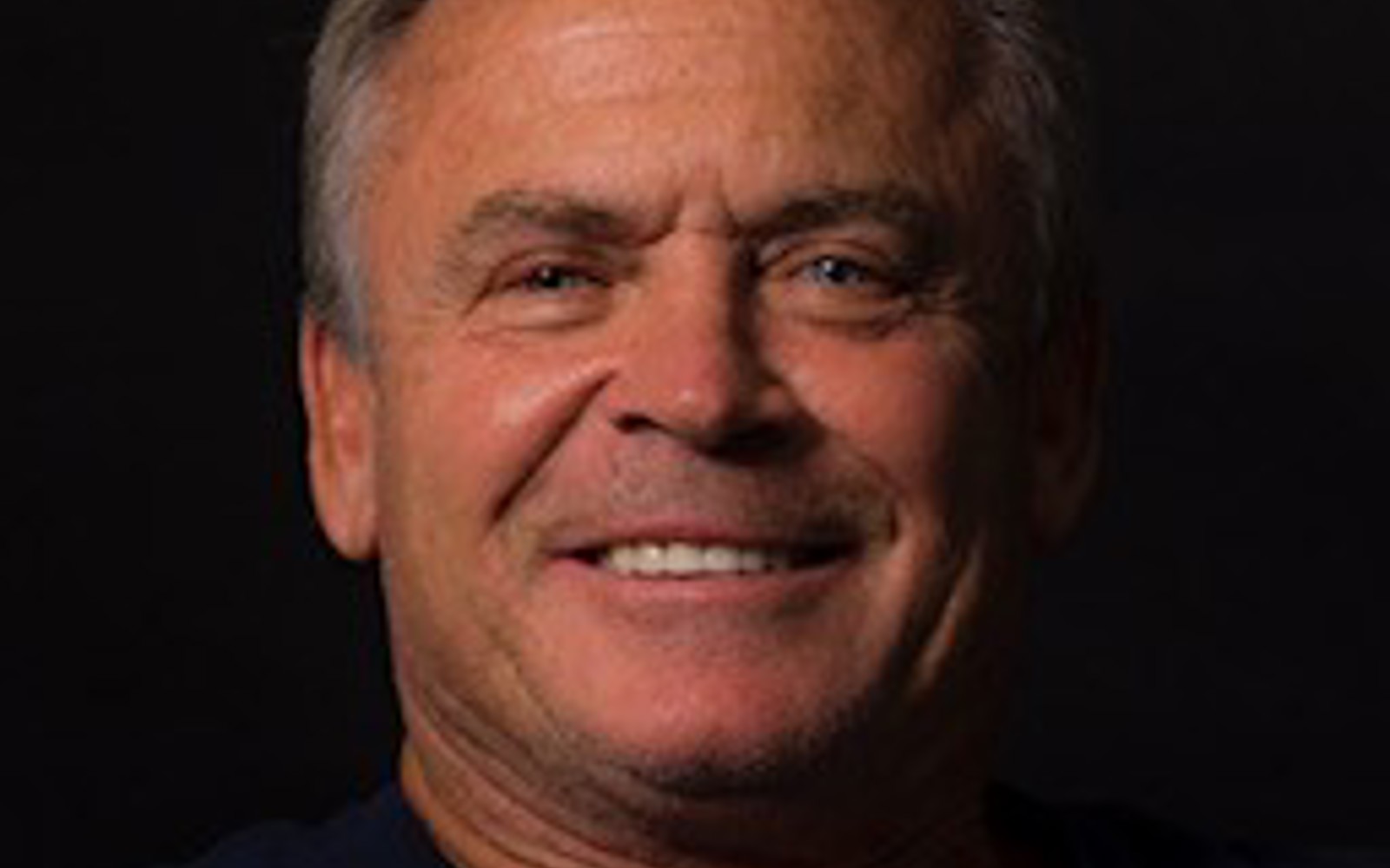 Headshot of a man in black tshirt 