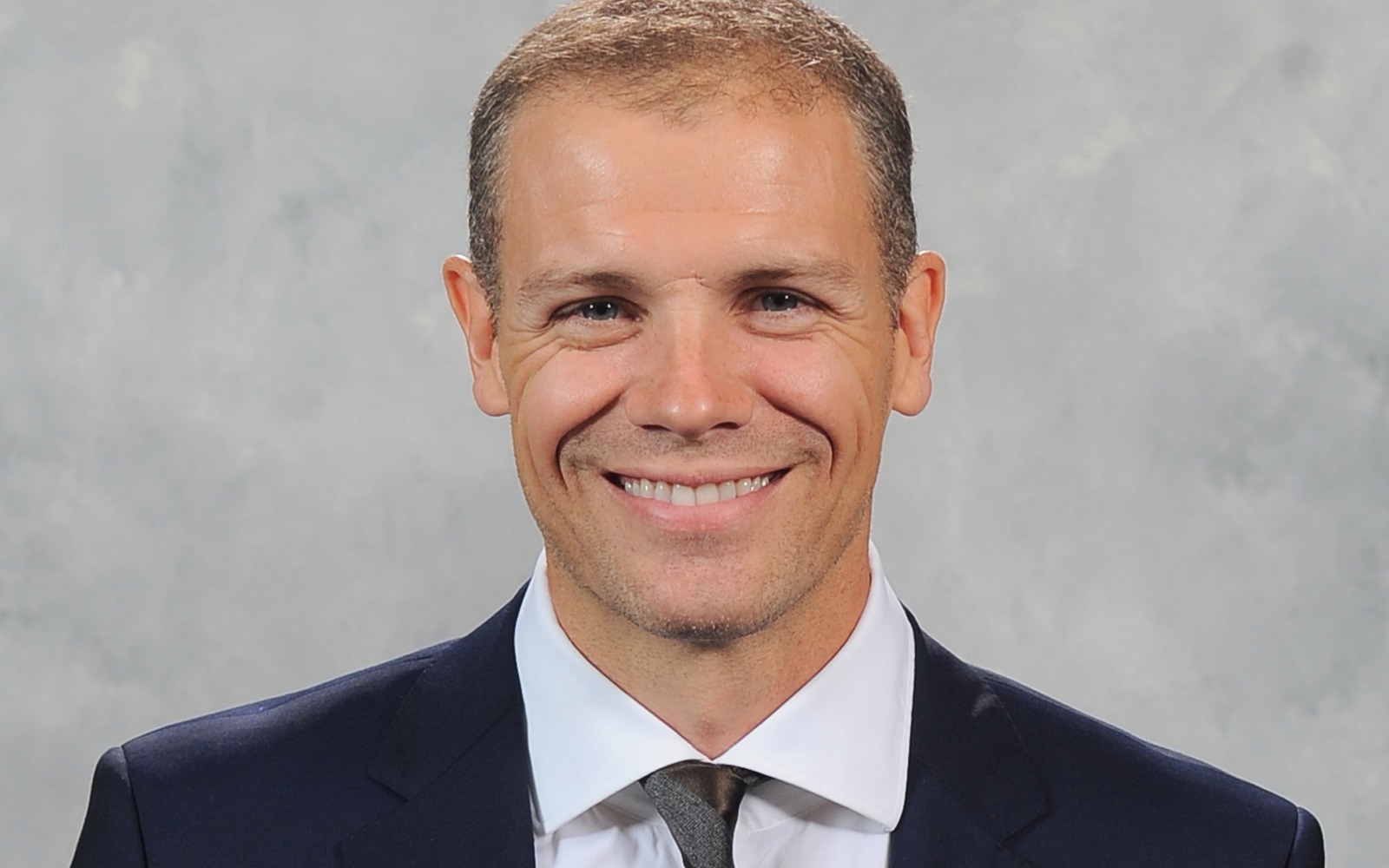Headshot of a man in a suit.