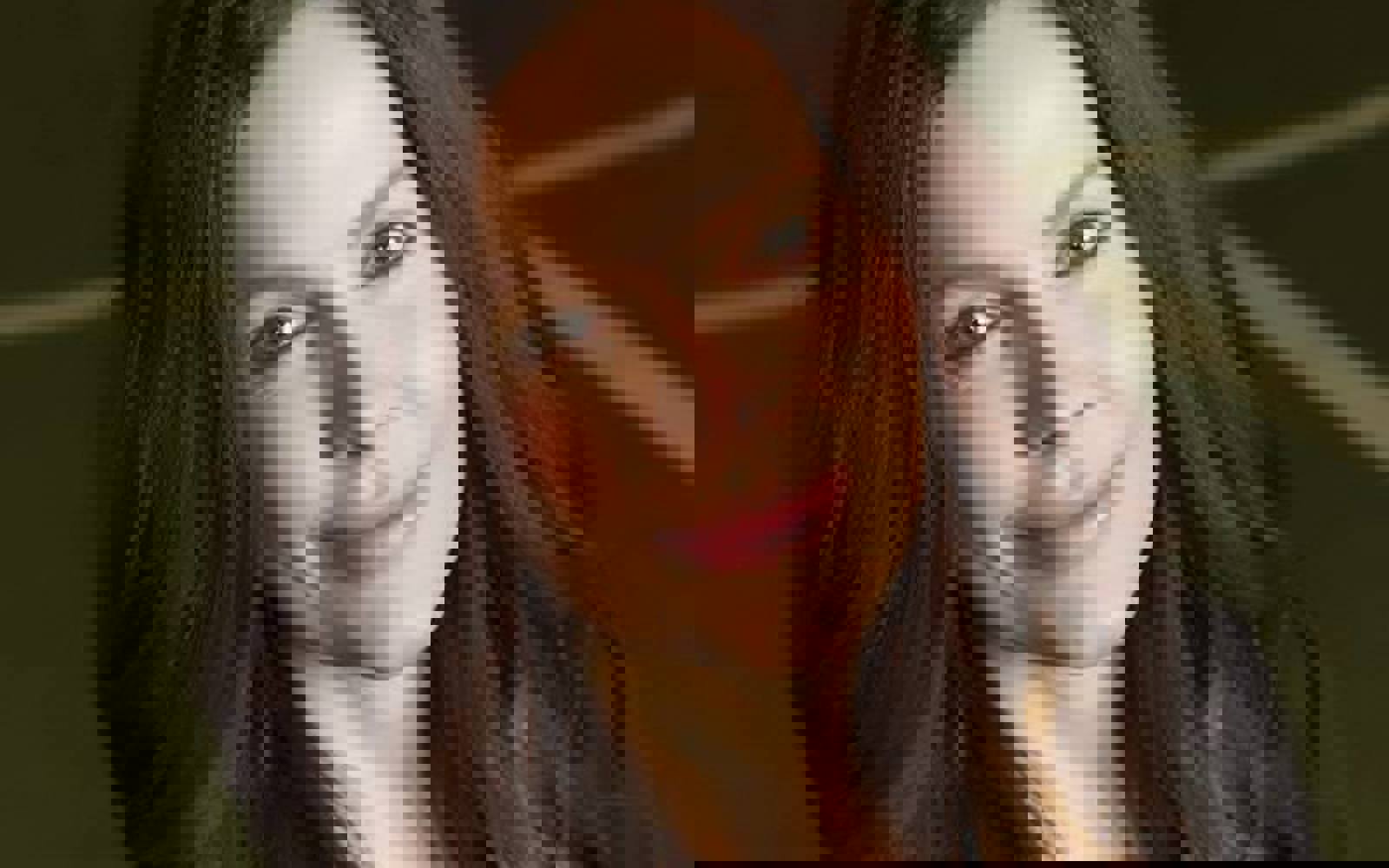 Headshot of a woman with long dark hair. 