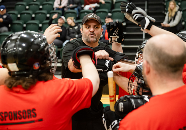 Floor Hockey team cheering; Special Olympics PEI, Floor Hockey Celebration, Coach with Athletes
