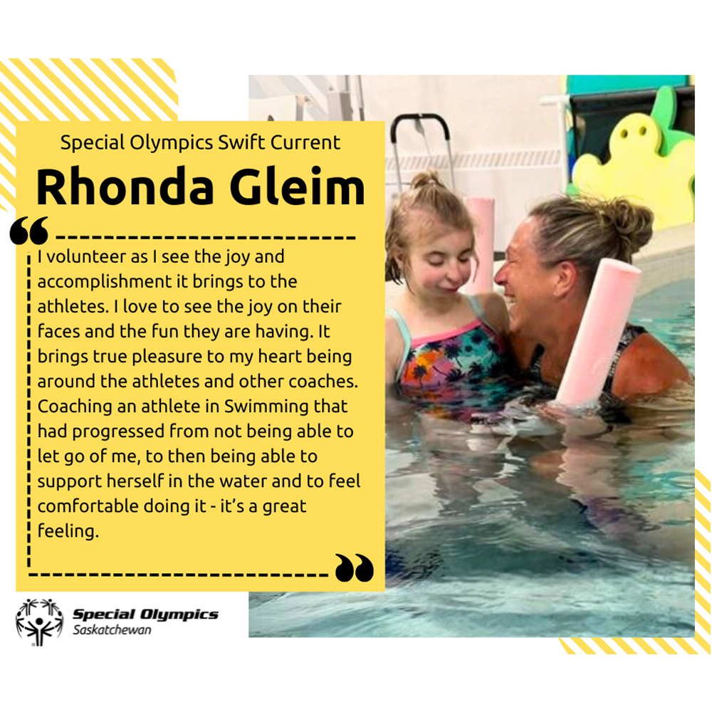 A photo of Rhonda Gleim in a swimming pool with an athlete. Rhonda is smiling very happily, looking at the athlete and is holding her in the water.