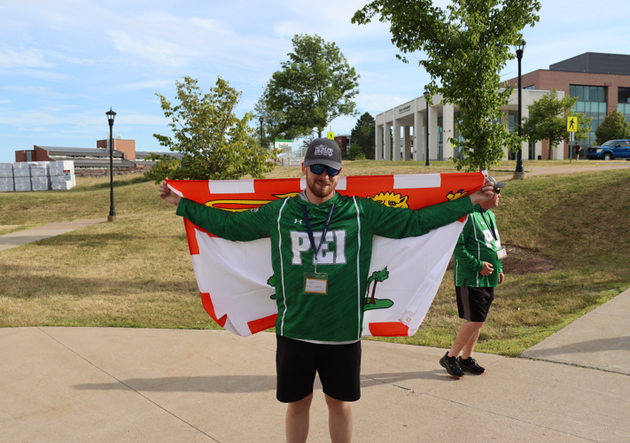 SOPEI Athlete Logan Robbins holding the Team PEI flag at the SONS games July 2025