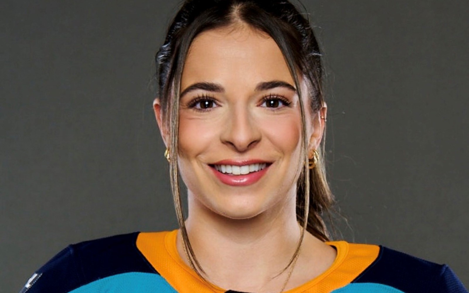 Headshot of a woman in a Sirens hockey jersey. 