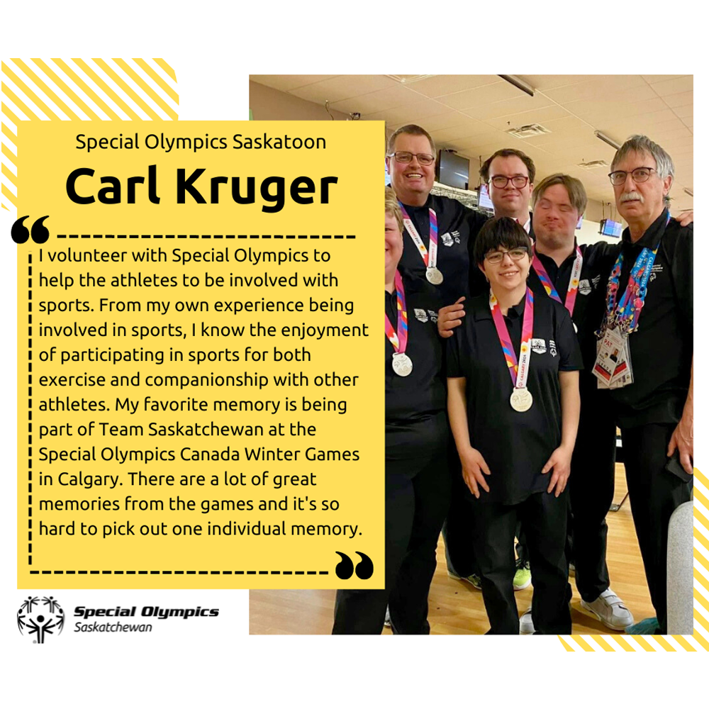 A group photo of Carl Kruger with some athletes. Everyone is wearing all black. The athletes have medals around their necks and Carl is wearing a volunteer lanyard.
